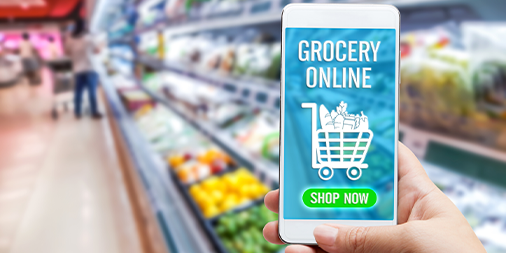 A hand with a smartphone that has online grocery app opened in the supermarket