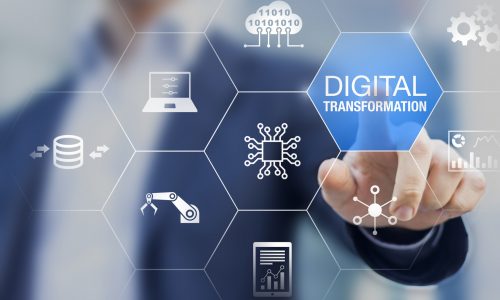 Man pressing digital transformation lit up in blue on digital screen.