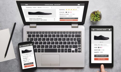 Online shop for black trainers on laptop, tablet and smartphone screen