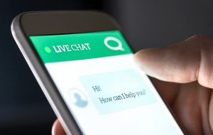 Close up customer service live chat with chatbot and automatic messages on phone being held 