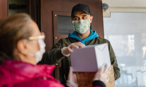 Senior woman getting a package from delivery person