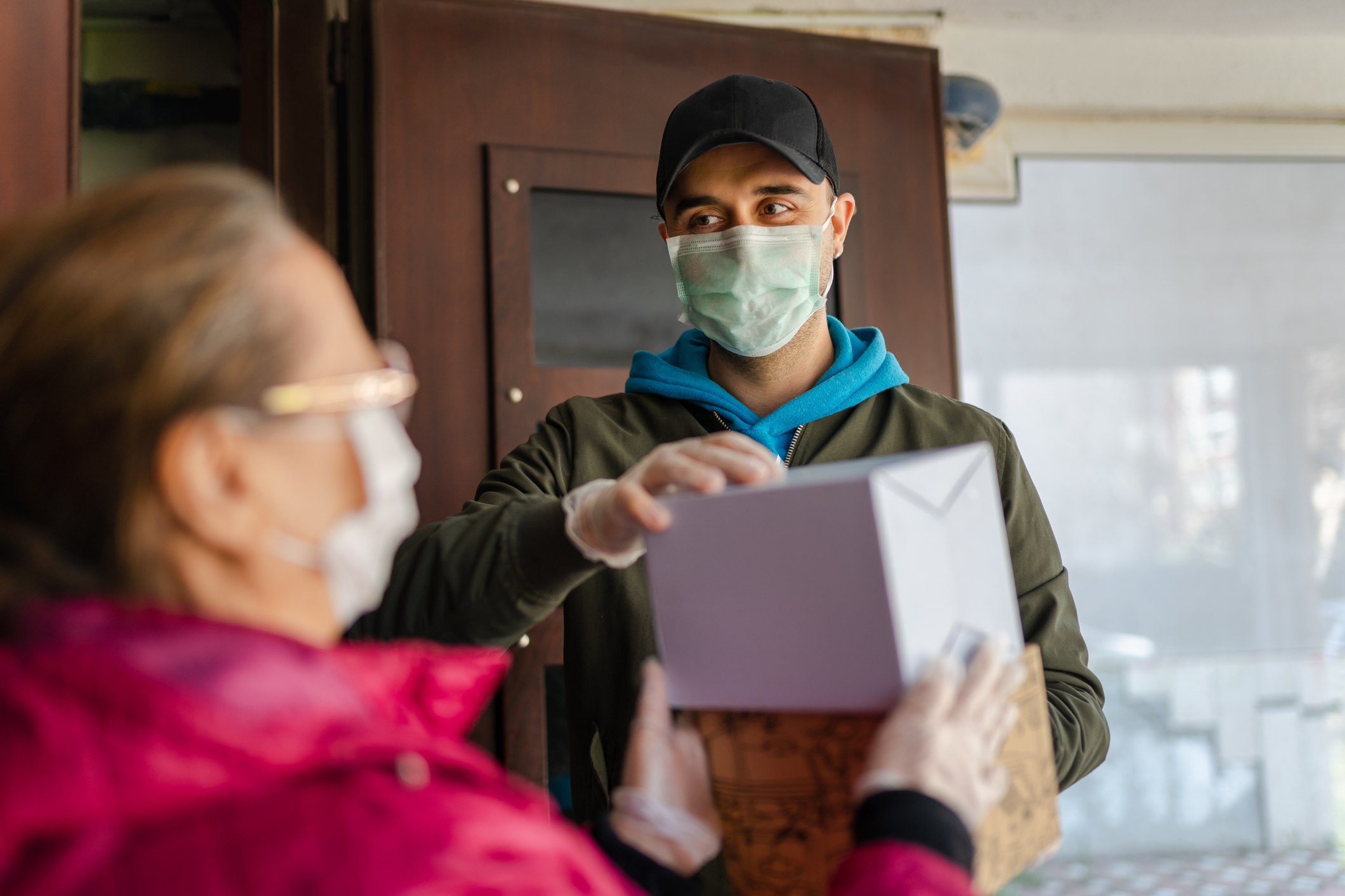 Senior woman getting a package from delivery person