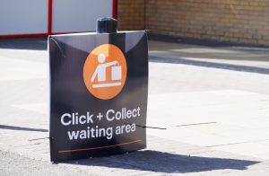 Click collect online internet shopping sign at shop car park lane