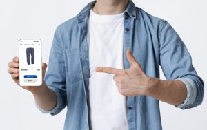 Man holding smartphone that advertises mobile shopping clothes website to order via internet.