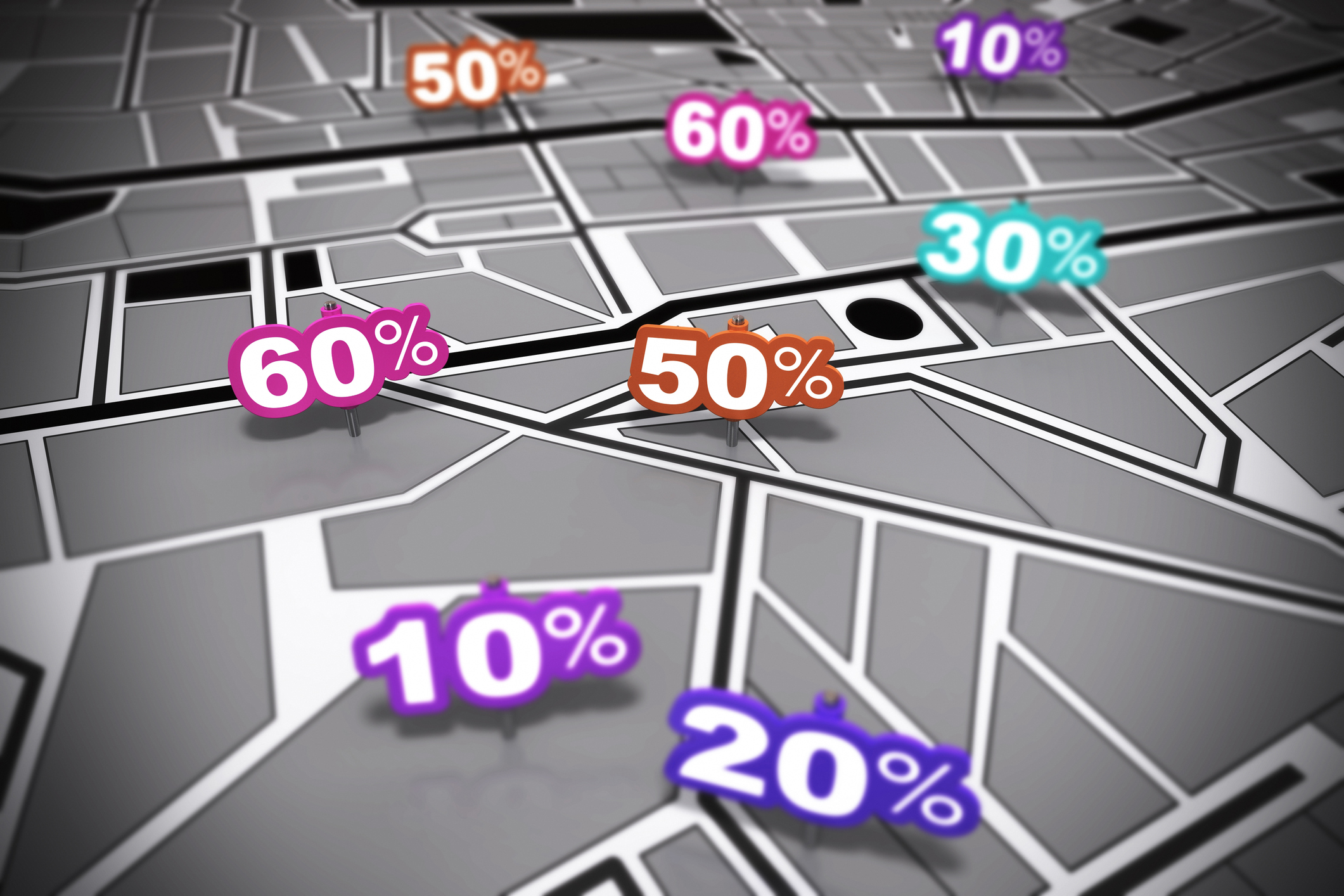 Many percent signs in different colours over a grey city map with focus effect