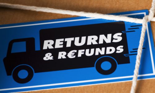 Close-up brown paper parcel with white string, blue return & refunds sticker featuring a black van.