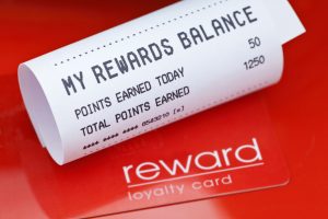 White receipt statement for a Loyalty Card Reward scheme with red loyalty card on red background.
