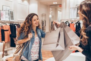 Young woman taking her shopping bags in a fashion store